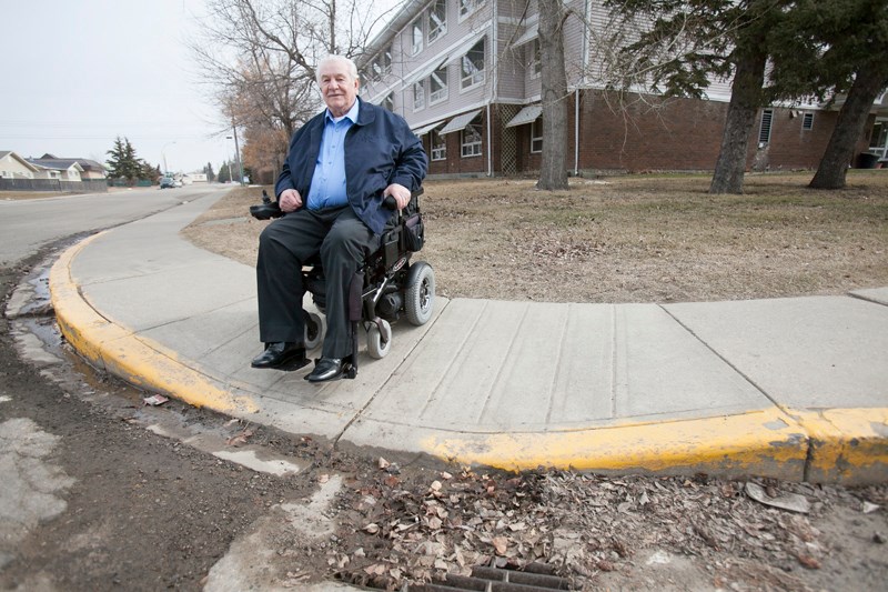 Vernon Hamm demonstrates how some sidewalk cutouts, such as this one at the intersection of 50 Street and 54 Avenue, are impossible for him and other people using wheelchairs 