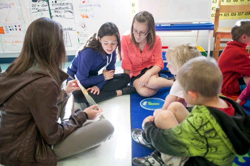 Students visiting from Quebec read to Olds Elementary School Grade 1 students during their tour around Olds on May 9.