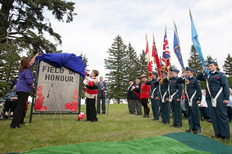 Brenda Beecroft (left) and Shirley Adams unveil the new monument during a Field of Honour Dedication ceremony at the Bowden cemetery on June 6.