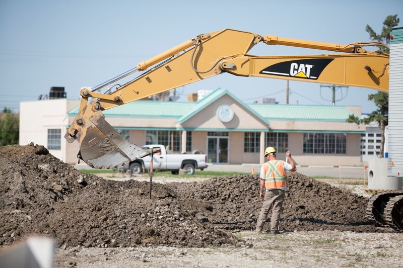 A construction crew works on the extension of 51 Avenue through the former Olds High School grounds on July 3.