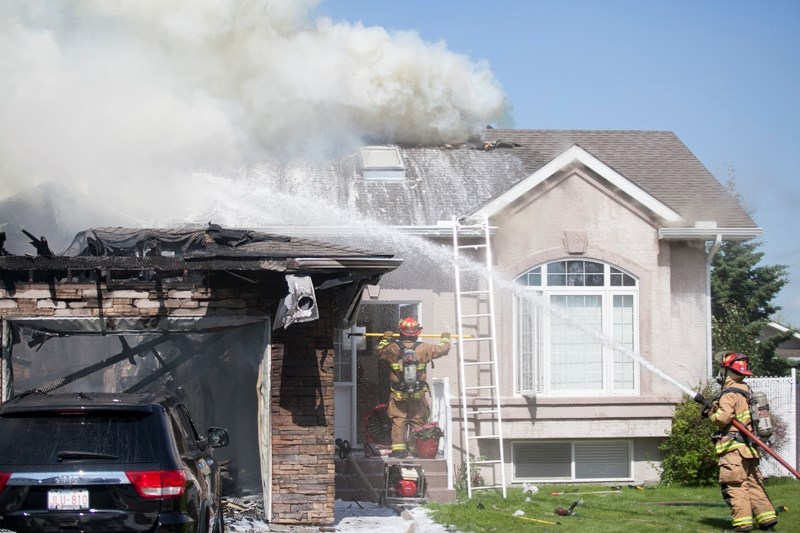 Firefighters battle a blaze that destroyed most of a home on Park Lane on the afternoon of July 1.