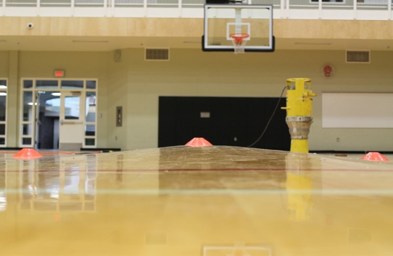 This photograph shows the buckling in the floor of the north gymnasium at the Ralph Klein Centre caused by flooding from a storm on June 29.