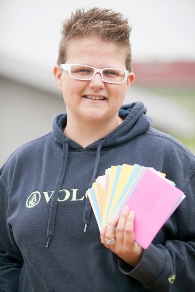 Andrea Barker holds a stack of letters of support at her home in Olds on July 22.