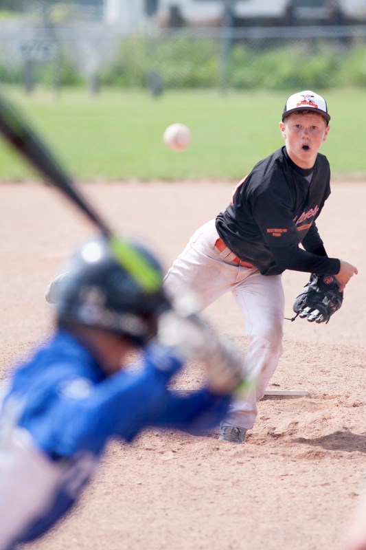 Shawn Hill of the Olds Spitfires pitches to a Stony Plain Royals player during the Spitfires&#8217; game against the Royals at O.R. Hedges park on July 26.