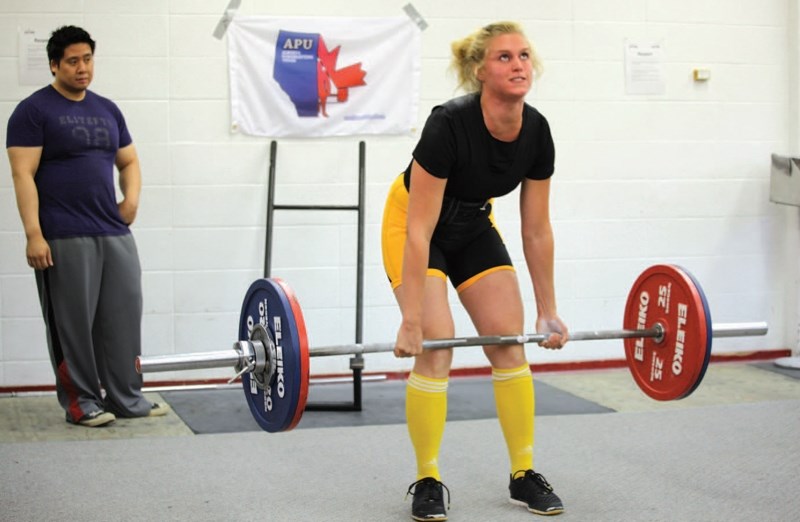 Olds Barbell Club member Ariel Chessall, seen here carrying out a dead lift, set provincial records for squat, bench and dead lift in the female junior athlete weight class