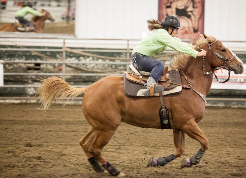 Kayly Monar of the River Valley 4-H Club out of Saskatoon, Sask., competes in the intermediate barrels section of the Calgary Stampede 4-H Rodeo at the Olds College riding