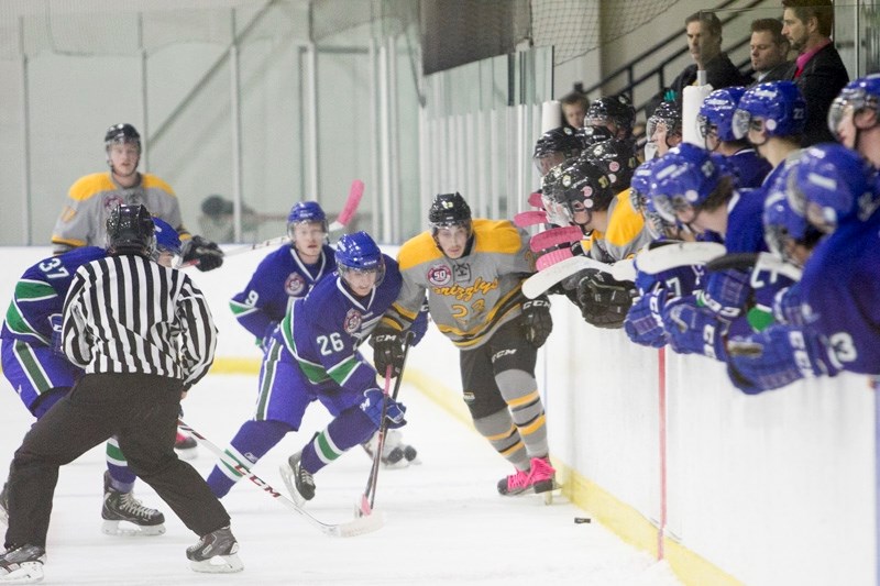 Olds Grizzlys player Dustin Gorgi battles with a Calgary Canucks player during their game at the Olds Sports Complex on Oct. 26. The Canucks won the game 2-1.