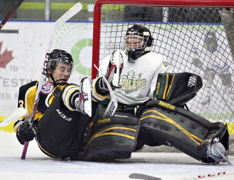 Western Wheel&lt;br /&gt;Olds Grizzlys defenceman Taylor Bilyk crashes into Okotoks Oilers goalie Jared D&#8217;Amico during AJHL hockey action in Okotoks on Nov. 1.