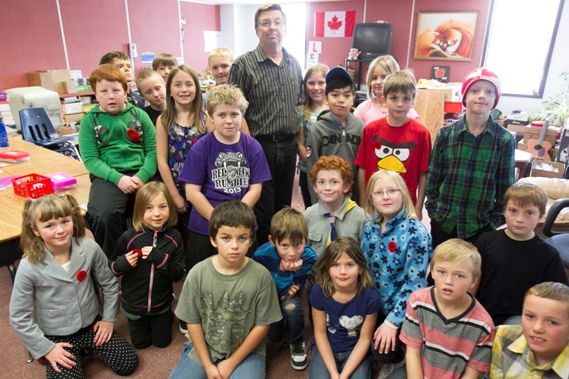 Olds Elementary School teacher Larry Steed poses with his students on Nov. 6.