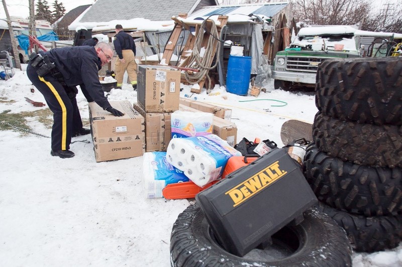 Members of the Olds RCMP remove as much as $40,000 in stolen goods from a 51 Street home on the afternoon of Nov. 8. The recovered items were stolen from homes and businesses 