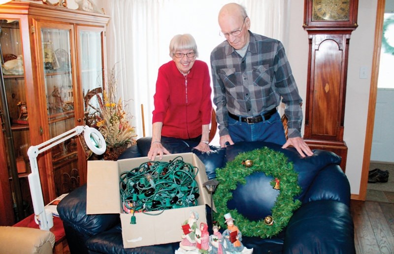 Marg and John Geisler show off some of the excess decorations they had in their basement that they plan on donating to people in High River and the Siksika Nation who were