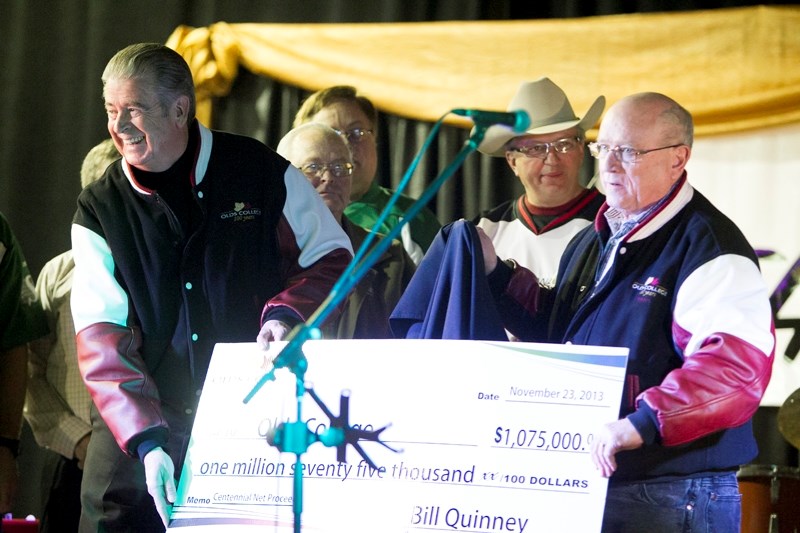 Olds College president Tom Thompson (left) and Barry Mehr, chair of the college&#8217;s board of governors, hold up a $1,075,000 cheque. The proceeds represented a surplus