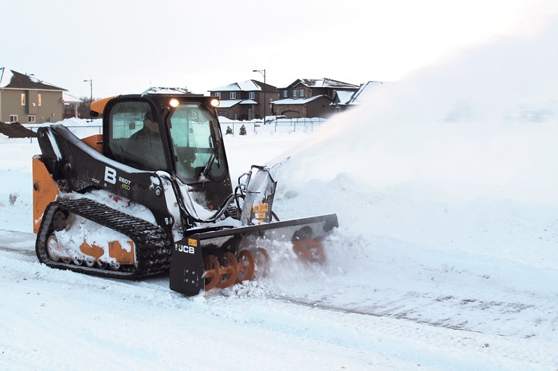 Two weeks after a blizzard blanketed Olds with snow, crews were still at work clearing roadways around the community. Here, snow is blown off a sidewalk on 57 Street near