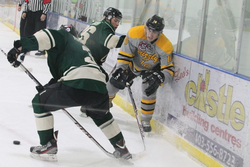 Grizzlys forward Marc Eremenko battles two Sherwood Park Crusaders players for the puck in the third period of play when Olds hosted the Crusaders on Dec. 21. Olds lost their 