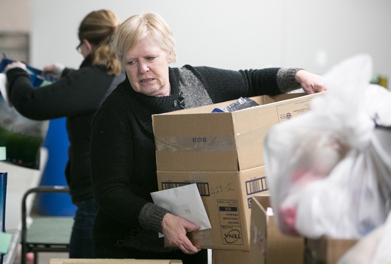 Volunteers with the Olds and District Christmas Angels sort out toys, etc. to be included in hampers for needy families in the community and area. Spokesperson Mary Jane