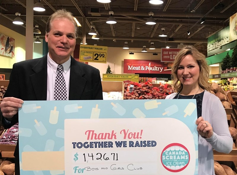 Olds Sobeys store owner-manager Robert Della Siega, left, presents Jamie Loreth, fundraiser and out-of-school coordinator for the Boys and Girls Club of Olds and Area with a