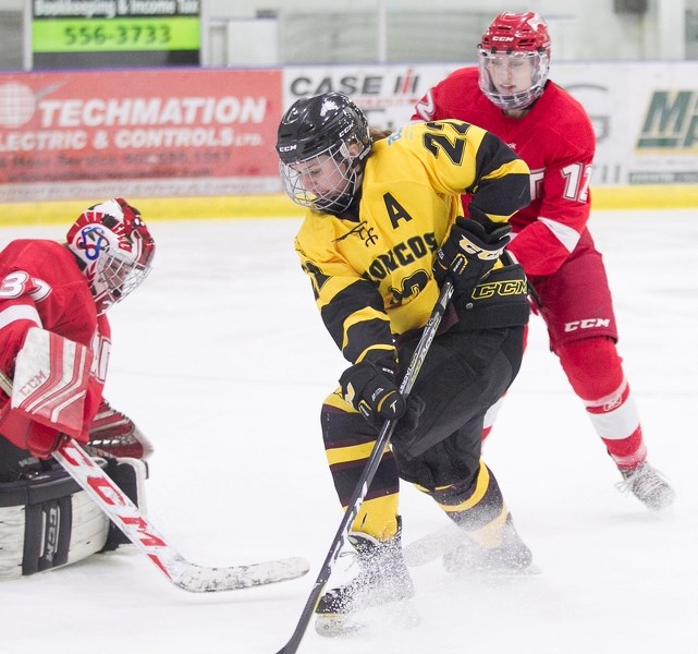 Olds College Broncos hockey player Krista Wilson puts pressure on at the SAIT Trojans net during a game at the Olds Sportsplex on Jan. 18. The team&#8217;s head coach, Chris