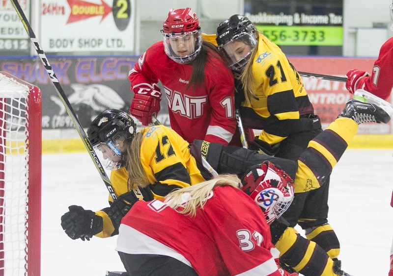 Olds College Broncos hockey player Hanna Matchett makes contact with the SAIT Trojans goaltender during a game at the Olds Sportsplex on Jan. 18. The Trojans won that matchup 