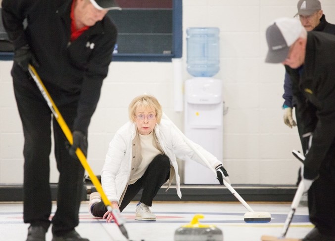 Elaine Graham throws a rock during the annual Olds Seniors Bonspiel at the Olds Curling Club.