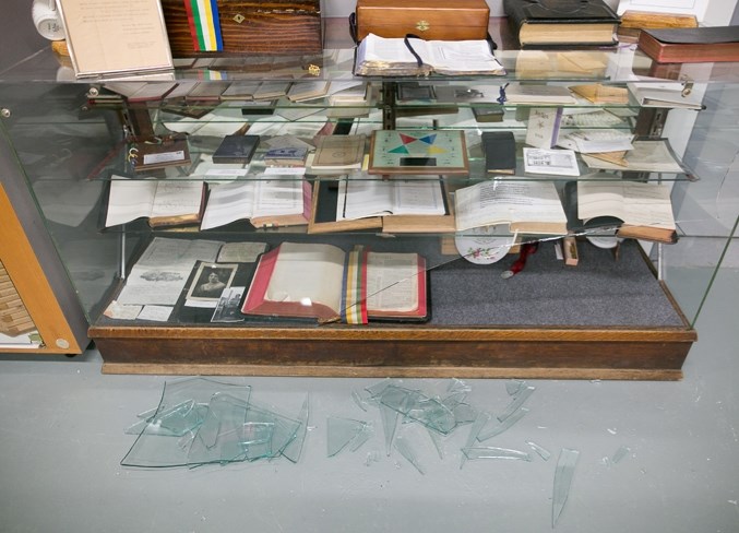 Broken glass in front of a smashed display cabinet at the Bowden Pioneer Museum on Feb. 1.