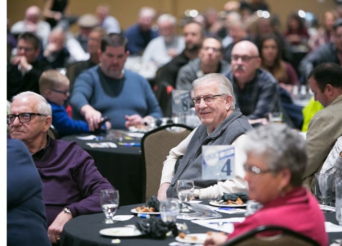 Members of the crowd listen to Calgary Flames president of hockey operations Brian Burke and Craig MacTavish, vice-president of hockey operations for the Edmonton Oilers,