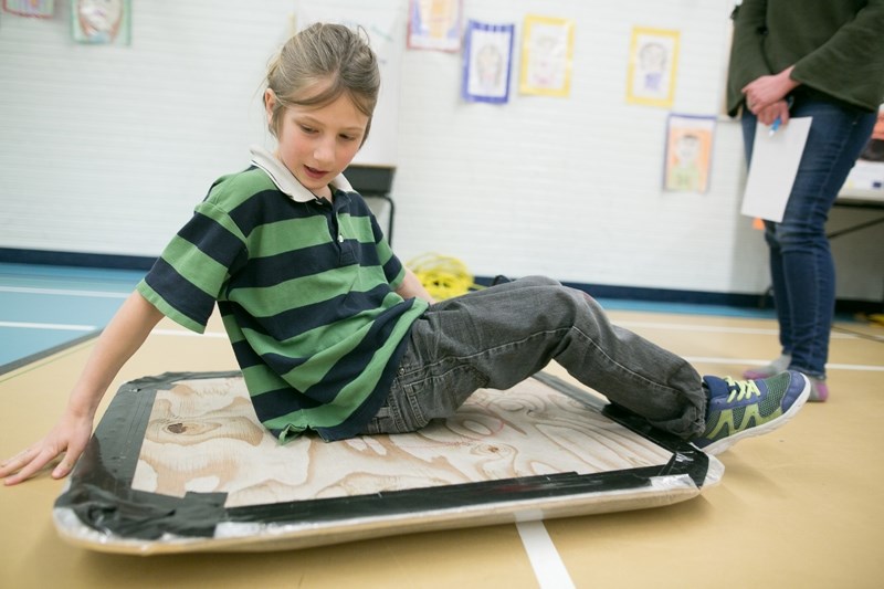 Grade 3 student Zeke Dangle shows off a hovercraft he created for the Olds Elementary School science fair.