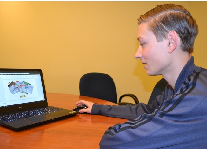 Jayden Ord works on recycling posters for his trip to Ethiopia, which begins this Friday.