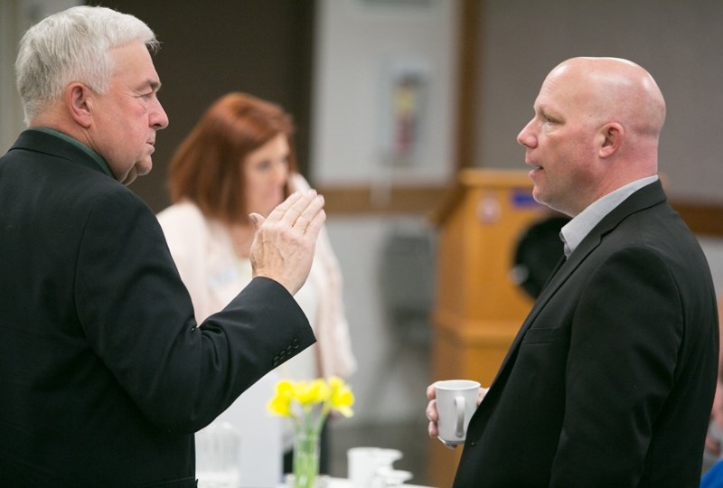 Town strategy and technology officer Larry Wright converses with Mayor Mike Muzychka during the Feb. 16 breakfast meeting at the Olds Legion.