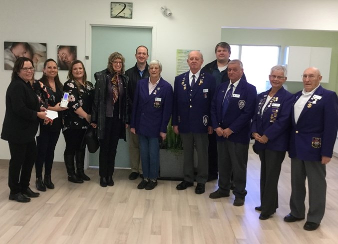 Employees of the Peaks to Prairies Primary Care Network (PCN), along with members of the Rotary Club of Olds and the Olds Elks Lodge #100 pose during a visit to see a