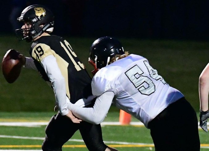 Rural Olds resident Nils Haeni grabs a quarterback.