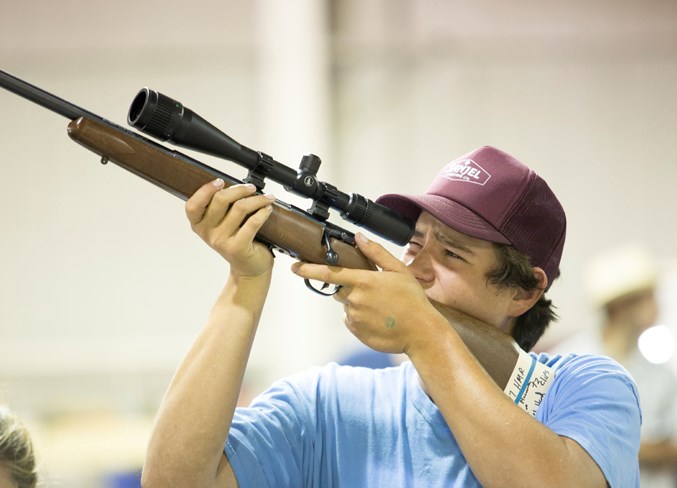 Ryley Kerr checks out a rifle during the event.