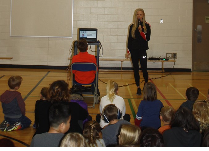 Olympian hurdler Sage Watson addresses Holy Trinity Catholic School students.