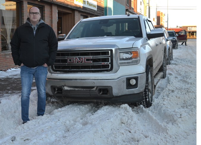 Drew Marceton stands on a snowy 51st Street in Uptowne on Dec. 5.