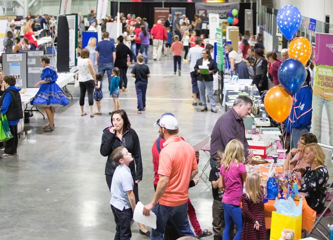 Visitors browse through the booths at a community registration event.