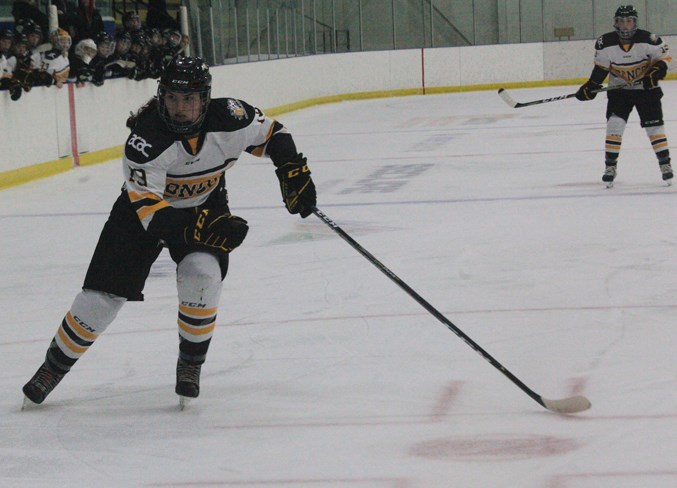 Abby Webster of the Olds College Broncos women&#8217;s hockey team heads up ice.