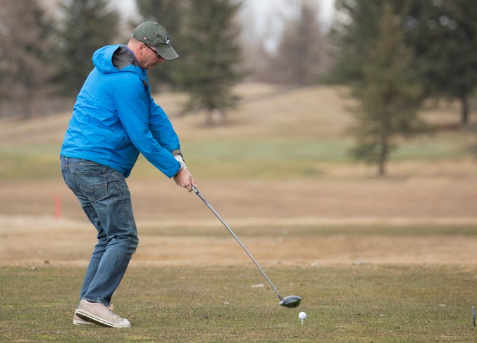 Jason Wright hits a drive shot at the Olds Golf Club on April 11.