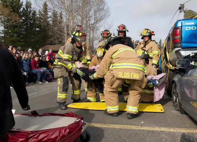  Olds firefighters move Tyler Weston to a body bag during the simulation. Noel West/MVP Staff