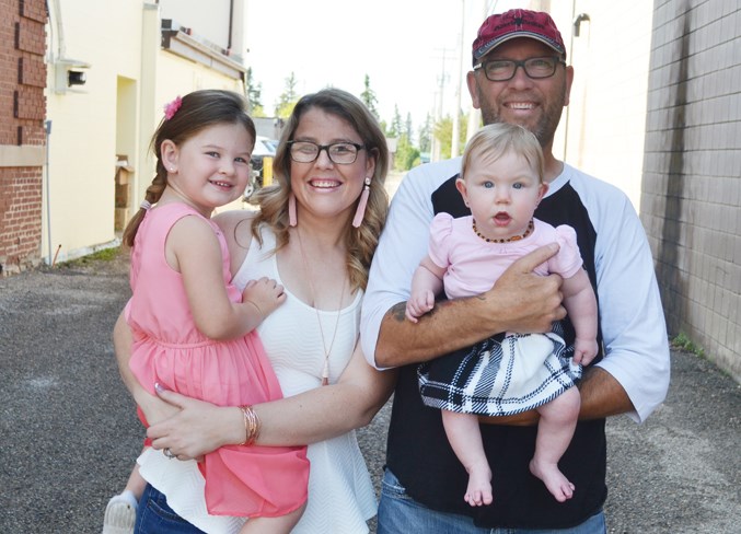 The Hall family: from left, Austin, Lindsay, and Stan holding Jessie.