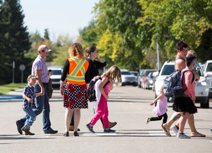 Students cross the street in front of Ecole Olds Elementary School on Sept. 3.