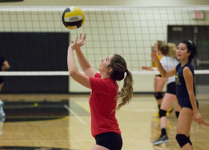 École Olds High School students take part in volleyball tryouts at the school.