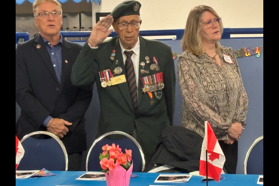 David Parks, left, Jim Parks and Crystal Parks stand for the Canadian national anthem.