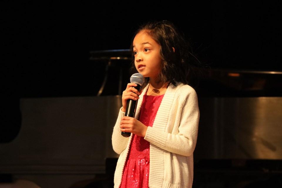 Eight-year-old Dia Anastacio takes the stage for the 25th Newmarket Voice Festival. The four-day festival featuring multiple categories of performing arts continues at the Old Town Hall on Botsford Street until Saturday, Feb. 25. Greg King for NewmarketToday