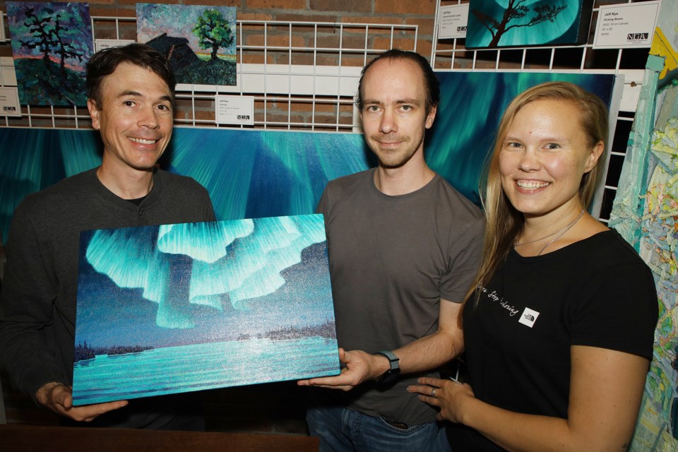 Newmarket artist Jeff Nye just sold one of his aurora borealis paintings to Matias and Alexandra Bretzm who are visiting from Germany. The event continues to 5 p.m. today, Oct. 6, in the Main Street area.