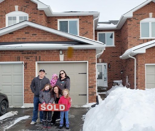 The Antle Family in front of their new home. Submitted photo