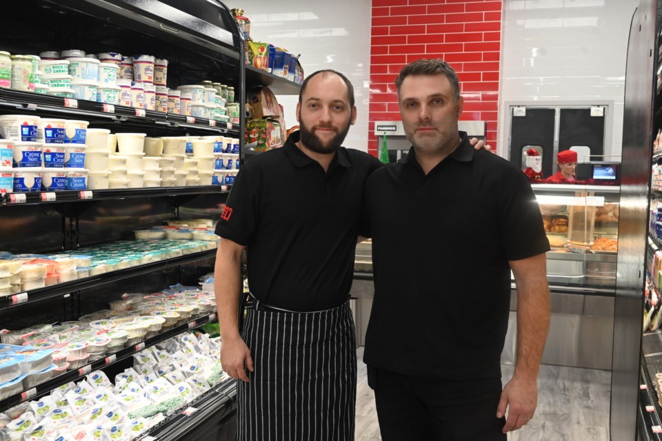 Leo Shisgal and his brother, Roman, stand in the new Angela's Deli location in Newmarket Dec. 4.