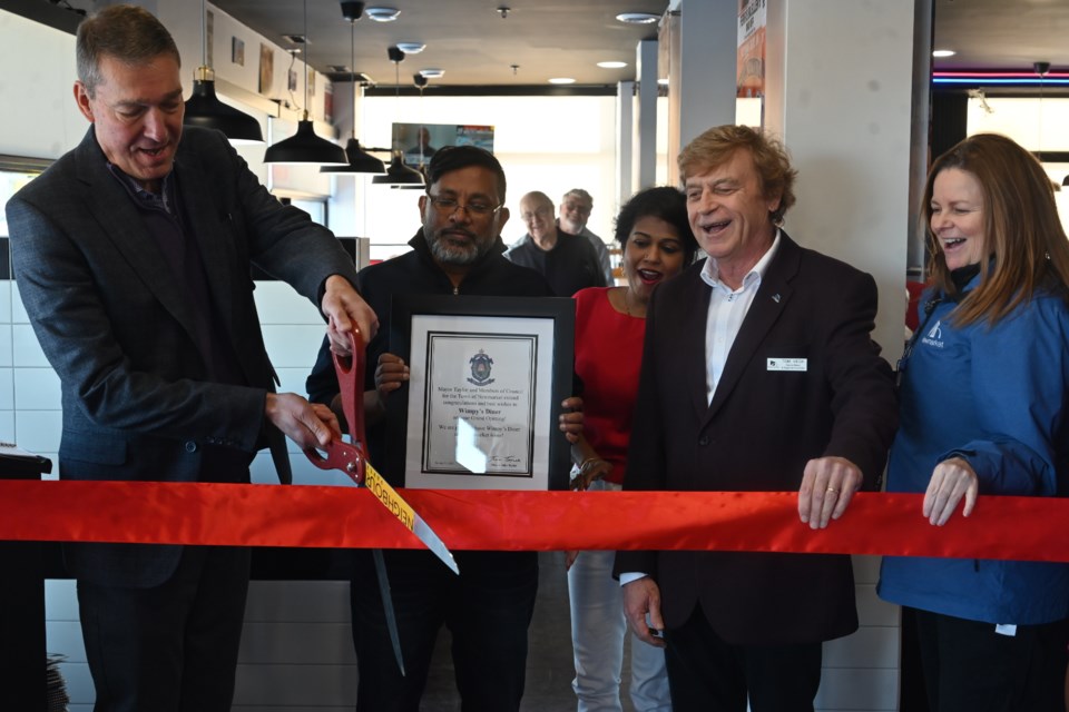 Newmarket Mayor John Taylor cuts the ribbon to open the new Wimpy's Diner in Newmarket, along with owner Pan Panchalingam, Sani Panchalingam,  Deputy Mayor Tom Vegh and Councillor Kelly Broome. 