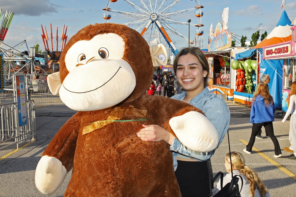 Olivia Sansalone won this giant stuffed monkey at the tubs of fun booth at the Joe Persechini Charity Midway continuing all weekend at the Ray Twinney Recreation Complex parking lot, in support of Easter Seals and Southlake Regional Health Centre.