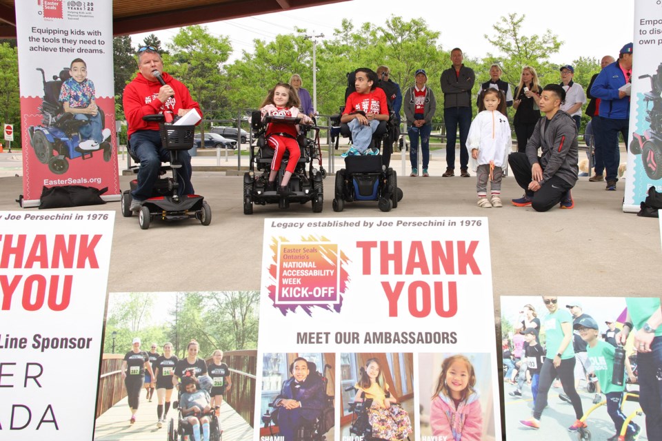 Easter Seals Ontario president and CEO Kevin Collins with 2024 Ambassadors Chloe, Shamil, and Hayley as the Easter Seals Run, Walk and Roll, the kickoff to Accessibility Week, at Riverwalk Commons in Newmarket May 26.
