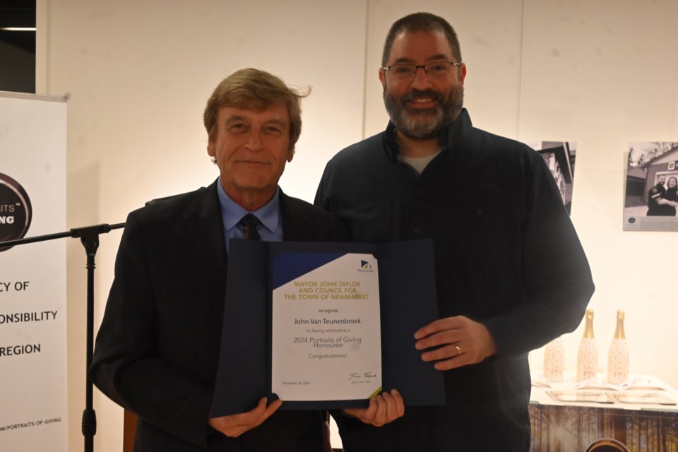 Newmarket Deputy Mayor Tom Vegh alongside Portraits of Giving Newmarket honouree John van Teunenbroek at a Nov. 26 ceremony at the Old Town Hall.