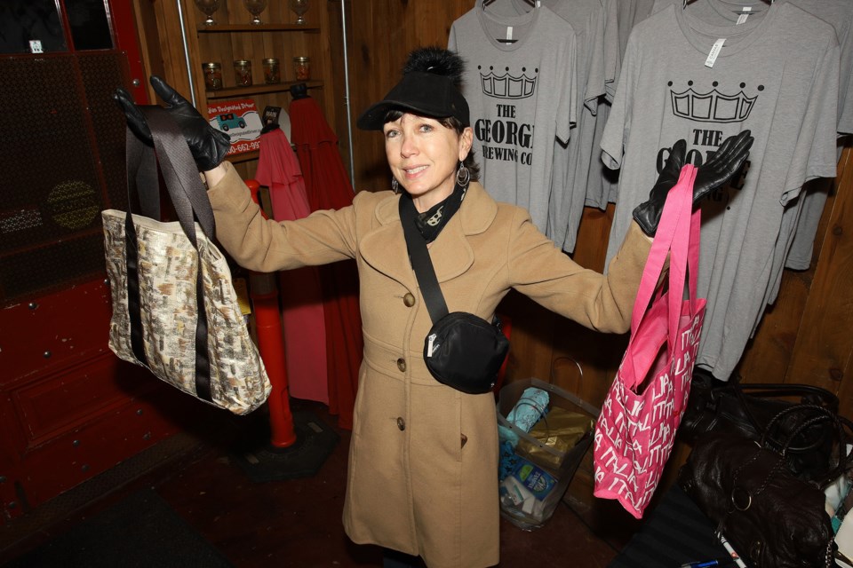 Newmarket resident Lisa Hoffman arrives at The George last night with her donations for the Fill a Purse for a Sister Campaign party.